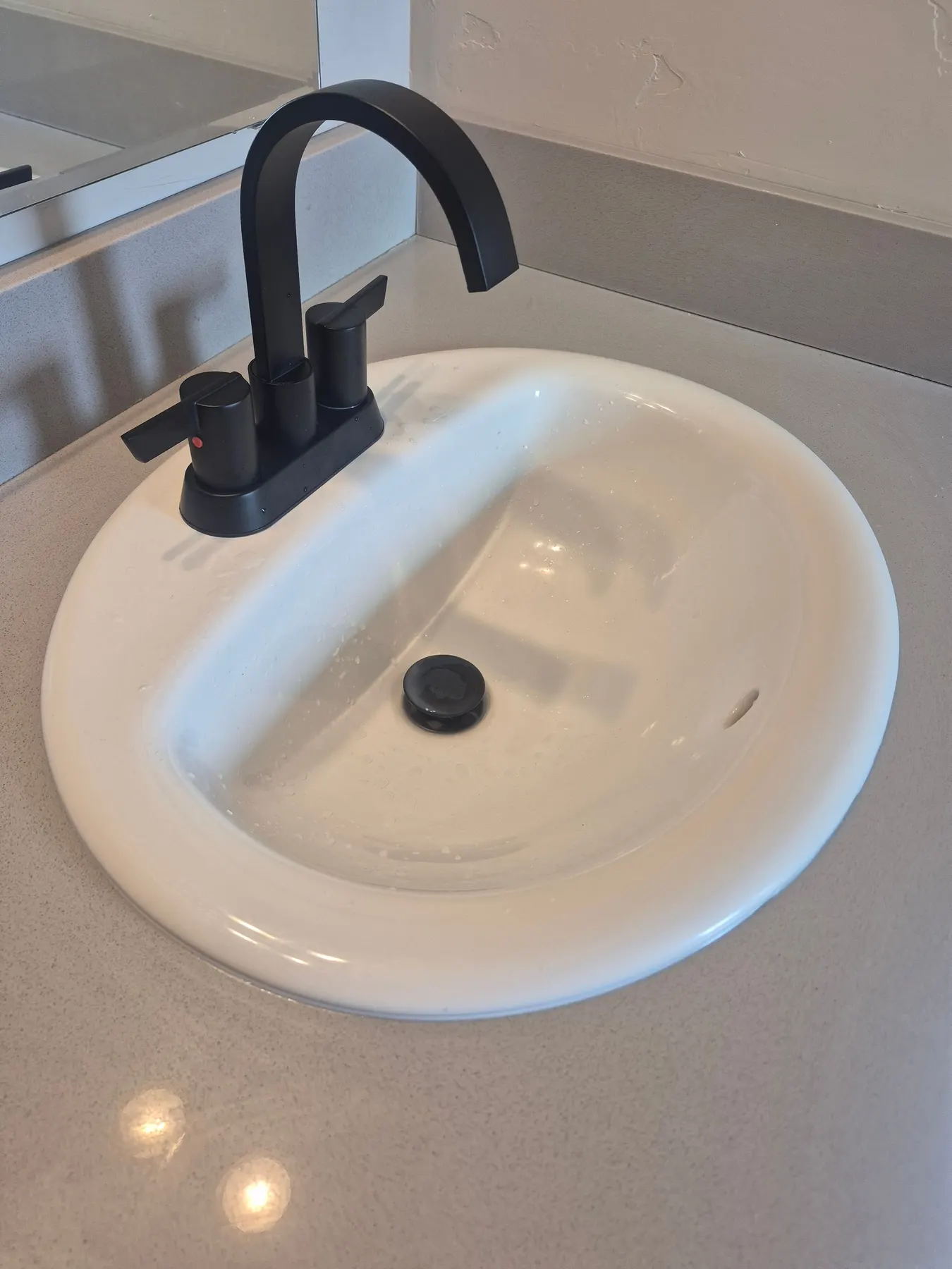 Bathroom sink with a matte black faucet