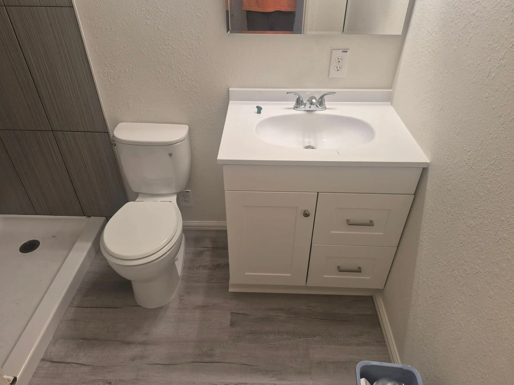 Finished bathroom with a new toilet and vanity