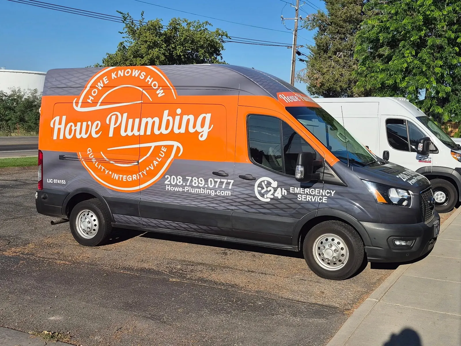 Howe Plumbing service van with the company logo and phone number