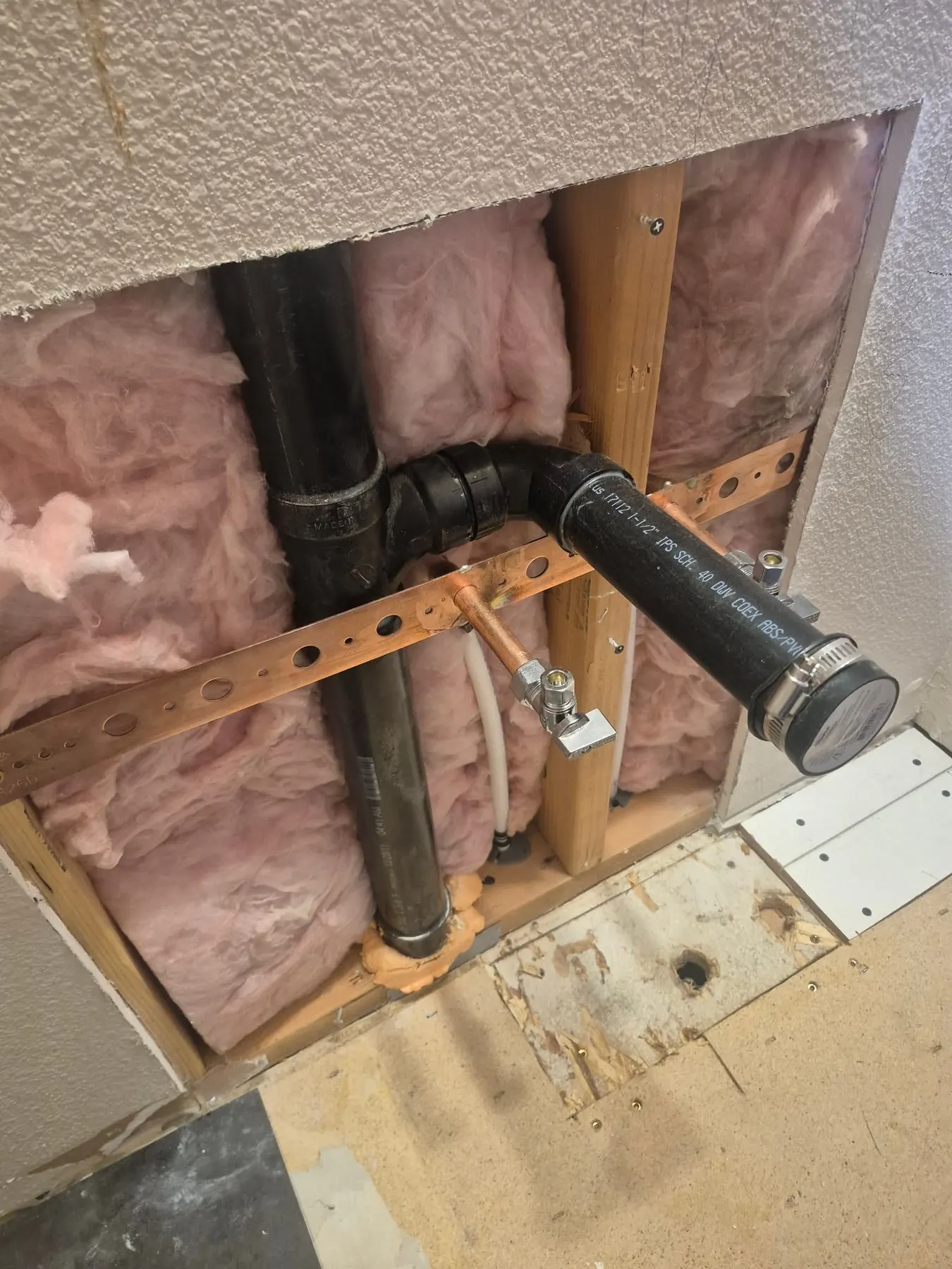Drain pipe exposed in an open wall