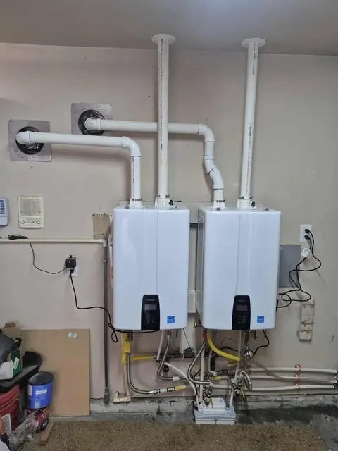 Two Navien tankless water heaters installed on a wall