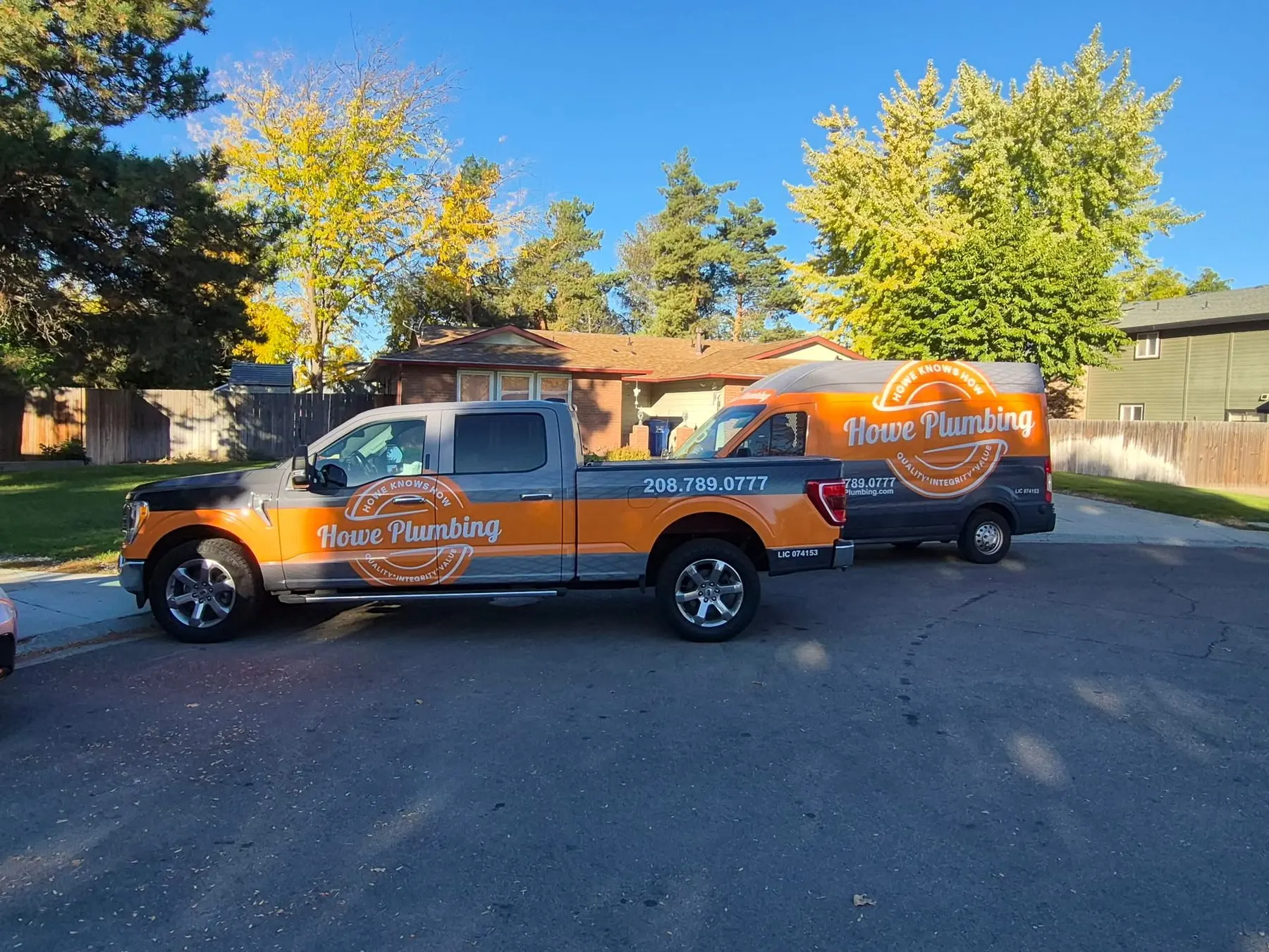 Howe Plumbing truck parked on a residential street