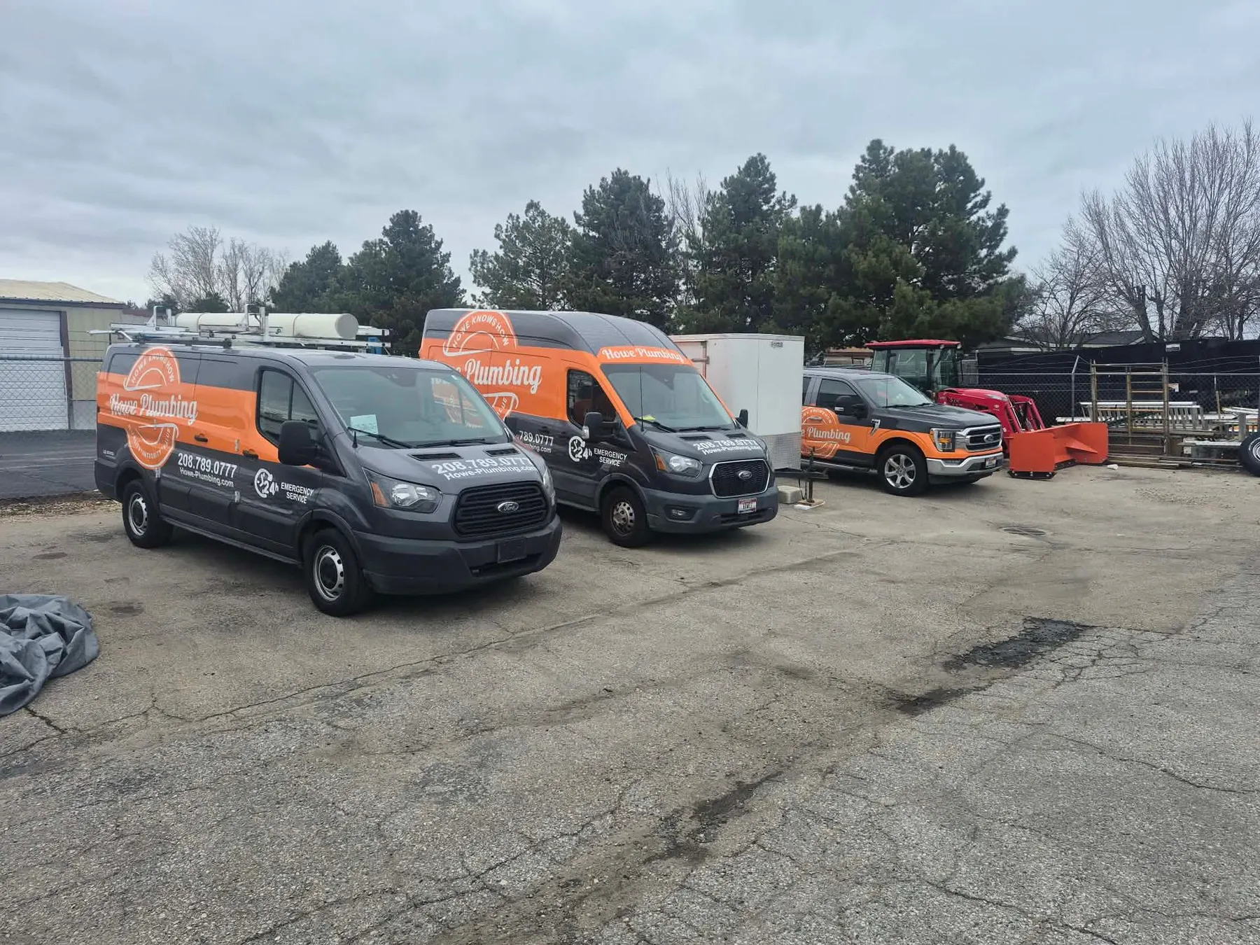 Howe Plumbing service vans parked at the shop